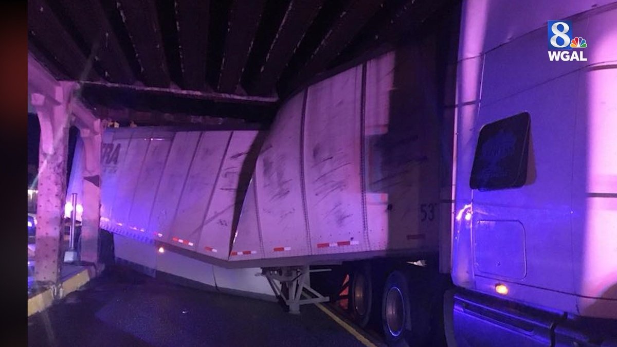 A tractor-trailer became wedged under a Cumberland County overpass early Friday morning.