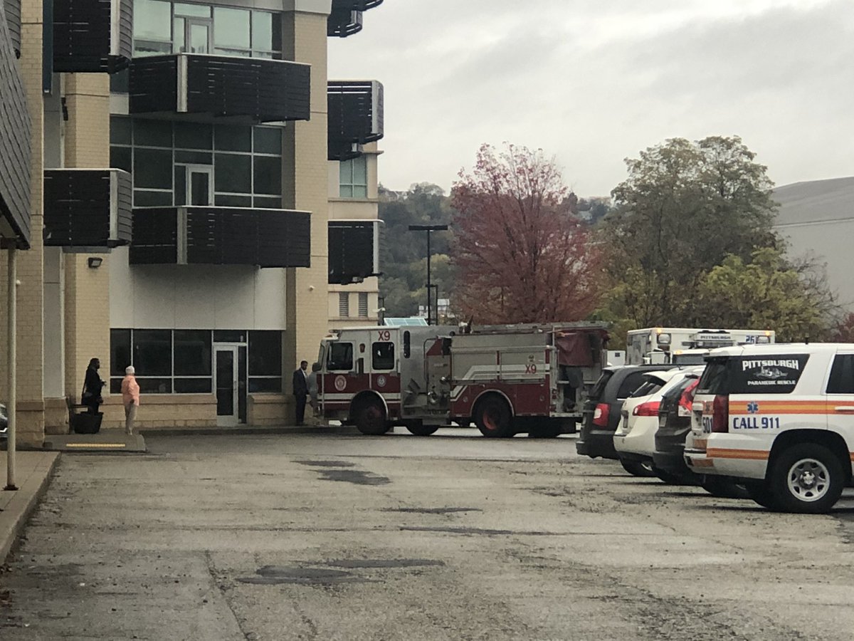 Bomb squad investigating suspicious car with language on driver side door outside Southside FBI HQ.