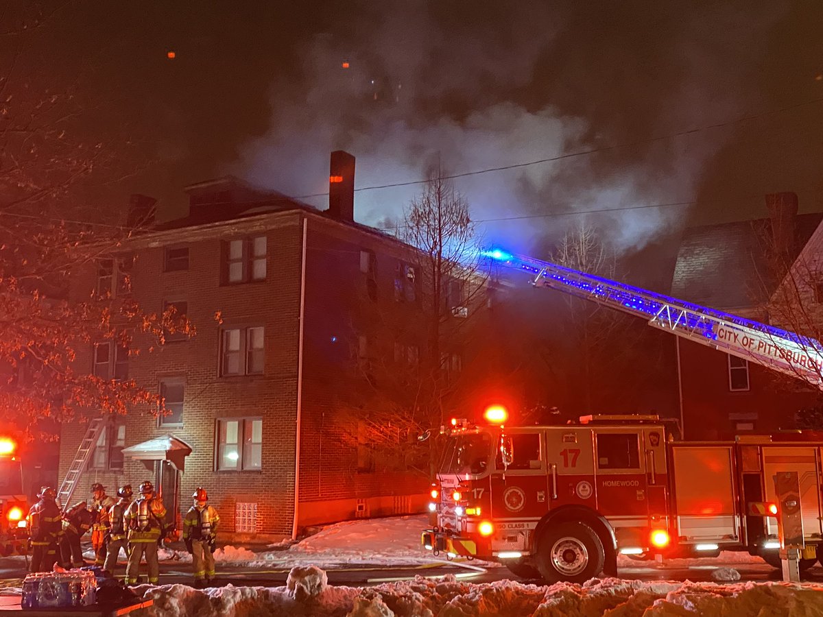 Crews on scene of apartment building fire on Pitt Street in Wilkinsburg; smoke coming from the roof