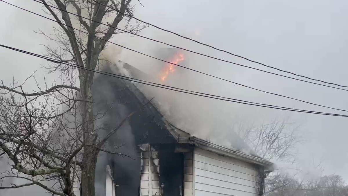 Flames now starting to come through the roof.  no one was hurt inside and in the neighboring home that is also damaged