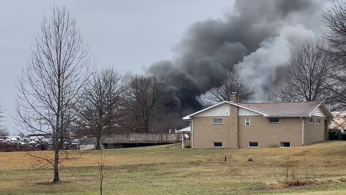 Closer to the scene. Flames still pouring from the structure. This is at Marsh Auto Salvage.  