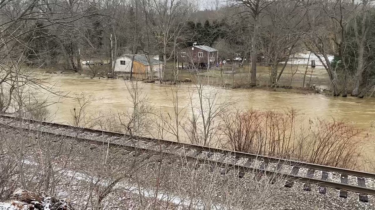 More from that area. Backyards are underwater for neighbors on the other side of the railroad here