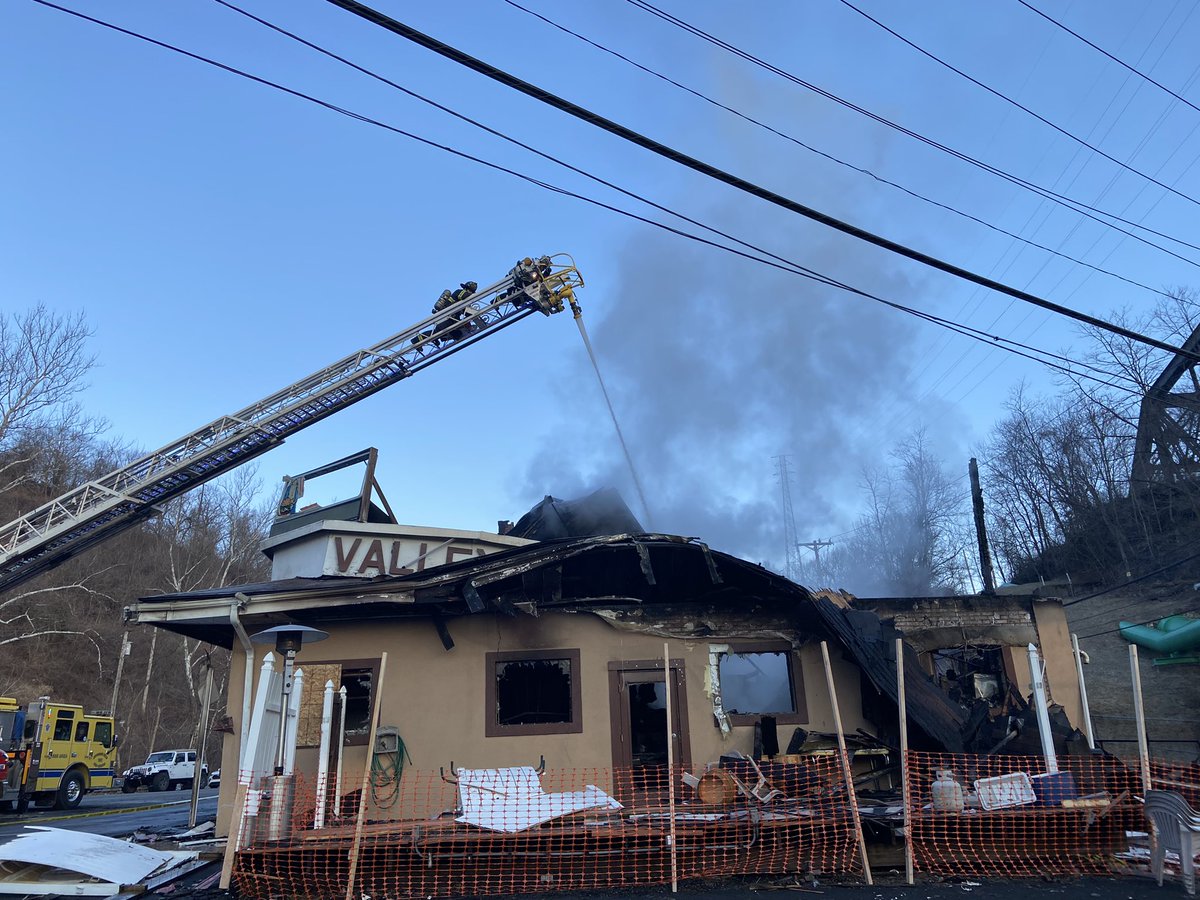 Firefighters dousing the rekindled Valley Hotel fire from above