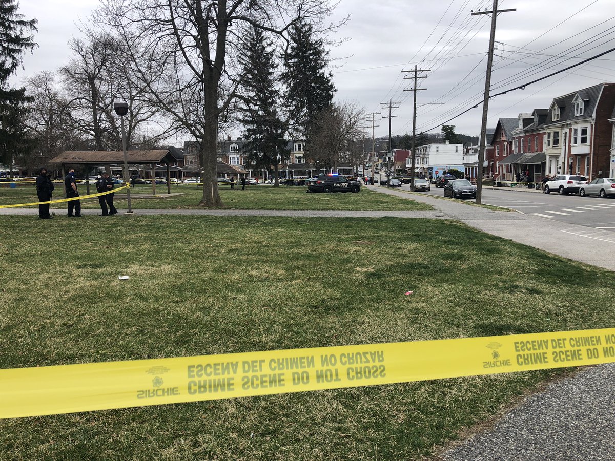 A large crowd has gathered near the homicide scene as @ycpda1 conduct the investigation. The park is right across the street from York High.