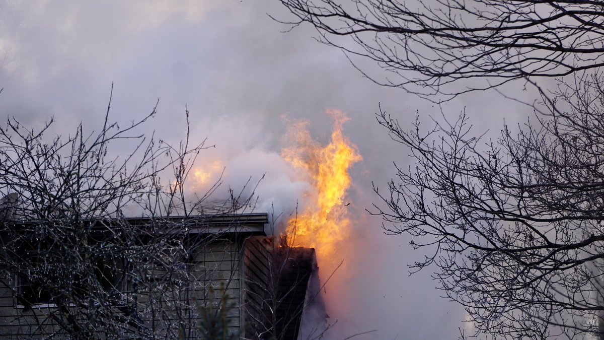 Flames coming from the roof of the Helen St. fire in Robinson Twp