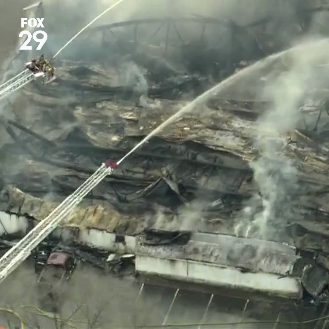 The roof of Levittown Lanes has collapsed as firefighters work to fully extinquish the three-alarm fire that destroyed the bowling alley 