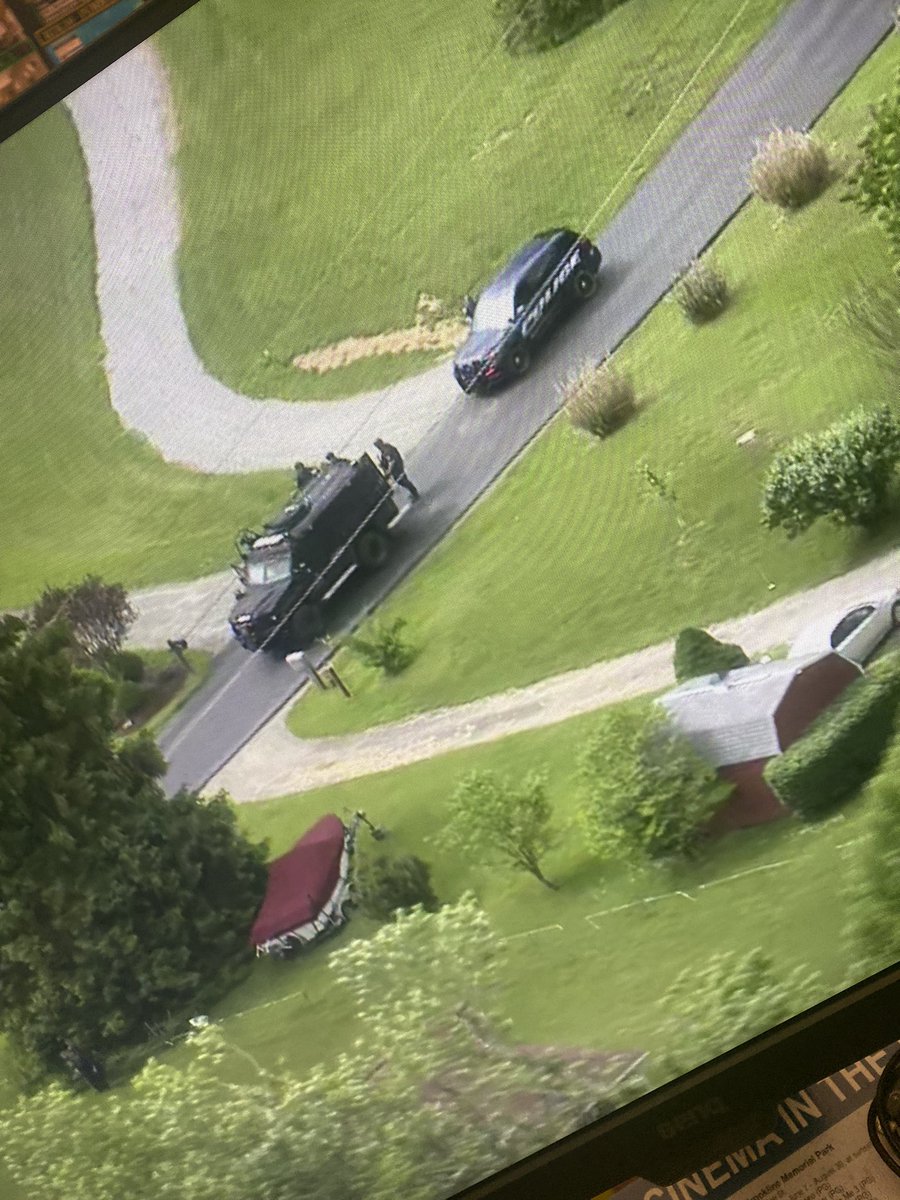 Swat situation:   a man surrender. not far from where we could see a body on a riding mower