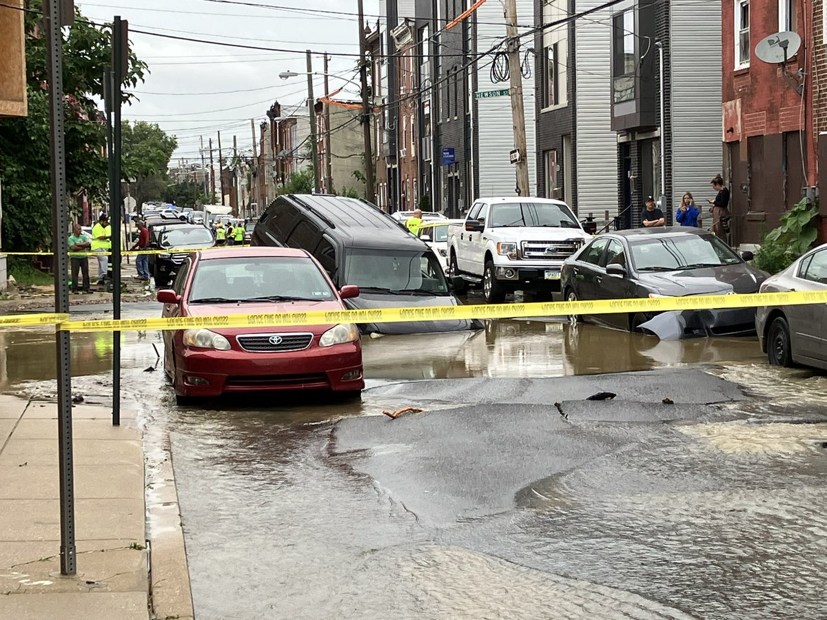 A major water main break on N. 4th & W. Hewson Streets in Philly leads to flooded basements and a car sinking into the street