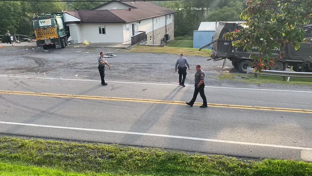 Two garbage trucks collide, sending one into building in Adams Township: One of the drivers has died