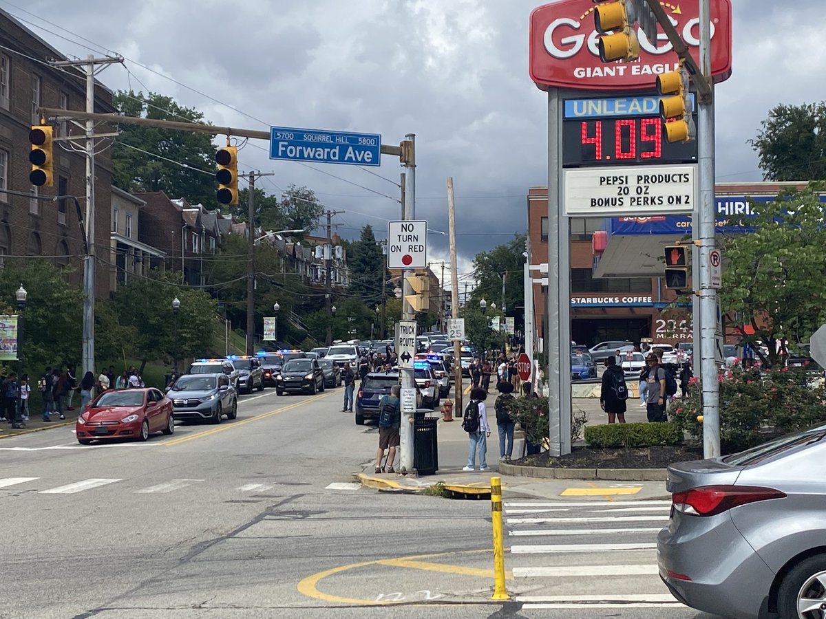 Dozens of kids and police remain at the corner of Murray Avenue and Forbes  Avenue where police say an officer was injured breaking up a fight