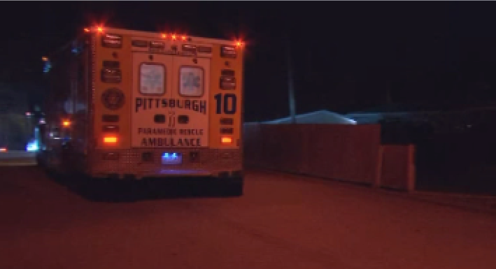 An ambulance leaves with its lights on from a State Police investigation.