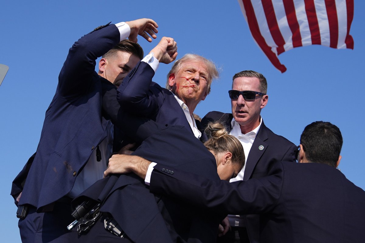 Donald Trump whisked off stage with bloody ear after loud noises rang through the crowd at rally