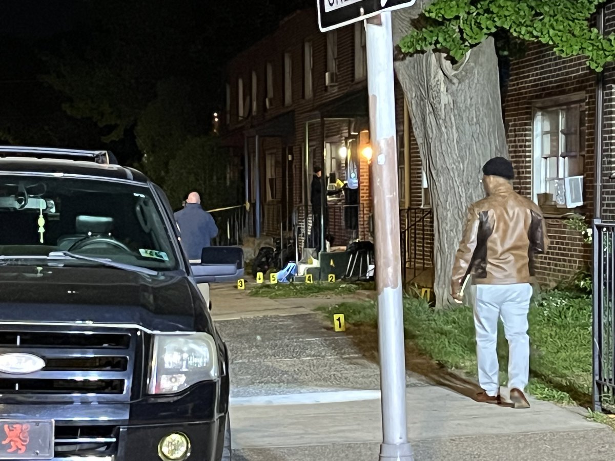 A man is dead while two others are fighting for their lives after they were shot while sitting on the front steps of this North Philadelphia house.
